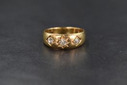 An 18ct gold diamond set gypsy ring, the central round brilliant cut diamond in a star motif