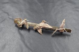 A silver woodcock brooch depicting three woodcocks in flight, each with gem chip set eye, approx