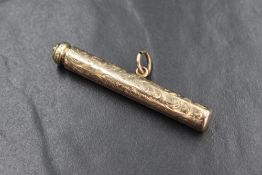 A yellow metal propelling pencil, having decorative scroll engraving with vacant rectangular