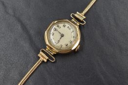 A 9ct gold wristwatch, the cream dial having Arabic numerals, on a 9ct gold snake bracelet strap,