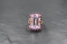 A 9ct gold amethyst ring by QVC having a large baguette cut amethyst within a border of small
