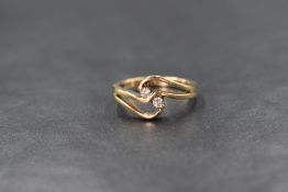 A 9ct gold diamond set ring, the two round brilliant cut diamonds measuring approximately 0.03ct