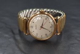 A 9ct gold cased Helvetia wristwatch, the champagne dial having Arabic and dot numerals, on an