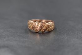A Victorian 9ct rose gold Keeper ring, the band having a woven motif with floral decoration,