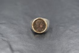 A silver and 14ct gold coin set signet ring, the imitation Roman coin in a yellow gold bezel setting