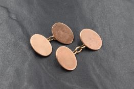 A pair of 9ct rose gold cufflinks, the oval panels of plain form having chain links, marked 375, 8.