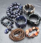 A stackers jewellery tray containing a small selection of modern costume jewellery including blue