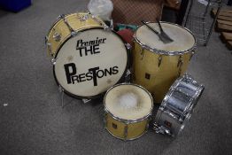 A vintage Premier drum kit comprising Bass drum, floor tom and tom, in gold glitter casings, and a