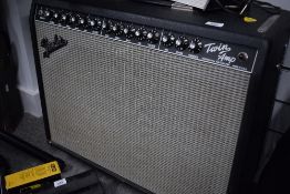 A Fender Twin Amplifier (Professional Tube Series) with three way footswitch (on castors)