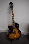 An Aria FA70 electric jazz guitar, left handed, serial number 106050407, sold with soft Warwick