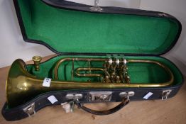 A traditional brass trumpet having rotary valves, no marking to instrument, mouthpiece engraved