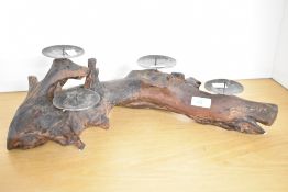 A contemporary driftwood centrepiece, having four metal pricket plates for pillar candles, unmarked,