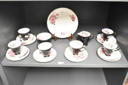 A 20th-century Old Royal Bone China tea set, featuring pink wild roses, shiny black exteriors and