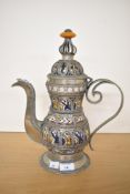 A 20th-century Moroccan ceramic and white metal tea pot, of an intricate decorative form,