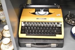 A late 20th-century Silver Reed Silverette portable typewriter, in bright yellow, 30cm, condition is