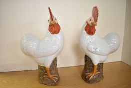 A pair of 20th-century Chinese porcelain rooster figurines, marked to base, 40cm, one of the