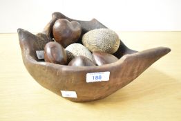 A contemporary reclaimed wooden bowl in rustic style, containing four turned wooden hearts and two