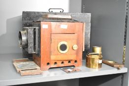 A Victorian brass mounted mahogany Magic Lantern with original wooden storage case, accompanied by a