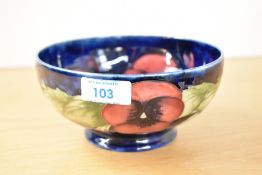 A 20th-century Moorcroft pottery Pansy pattern bowl, featuring deep pink and purple pansy buds and