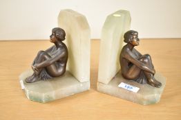 A pair of early twentieth century alabaster and bronze Art Deco figural bookends, featuring two