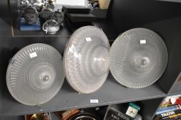 A quantity of three vintage Holophane glass pendant lights, (3), condition is consistent with age