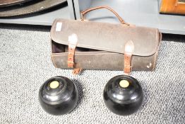 A 20th-century set of Thomas Taylor of Glasgow bowling balls in a leather carry-case, (2 balls and 1