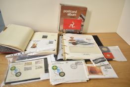 Isle of Man interest* A post card album, stamp album and first day covers (various and incomplete)