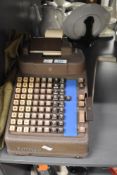 A vintage Burroughs metal Portable Adding Machine, a mechanical calculator used for accounting and