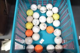 A quantity of modern golf balls, (approximately 26), condition is consistent with use.
