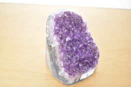 A 20th-century Amethyst geode, featuring a deep purple quartz, 12cm in height.