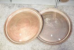 Two large 20th-century presumed Middle Eastern decorative copper trays, featuring embossed and