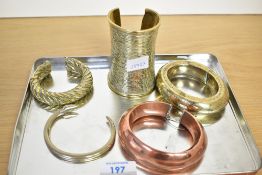 A quantity of 20th century African brass, metal and copper cuff bracelets, to include a twisted