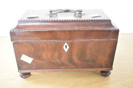 A Victorian mahogany tea caddy, of sarcophagus form, with brass handle, inlaid trim detailing,