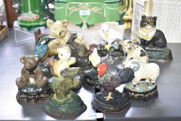 A selection of twelve small vintage cast iron animal doorstops, the whimsical group includes a teddy
