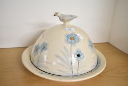 A large modern studio pottery cheese dish with domed cover, featuring a hand-painted snake, flowers,