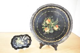 A 20th-century toleware decorative plate, featuring a hand-painted floral design and repeating