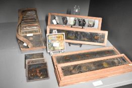 A large quantity of Victorian Magic Lantern glass image slides, typically made of two sheets of