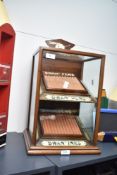 A 'Swan Pens' shop-counter mahogany display cabinet with three inclined fitted shelves, glazed to