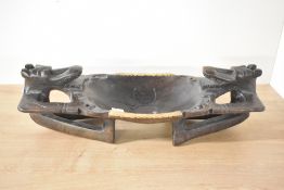 An interesting tribal carved hardwood bowl, of dished oval form with plaited grass sides and