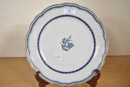 A Victorian Royal Doulton-style ceramic plate, featuring a blue floral pattern, with a scalloped
