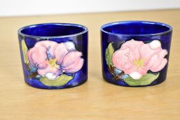 Two 20th-century Moorcroft 'Magnolia' pattern miniature bud vases, featuring tubelined foliage