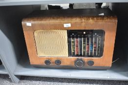 A vintage 1950's PYE walnut veneered radio, of typical form with glass tuner scale and metal speaker
