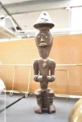 A late 19th to 20th century African Tribal Art hand carved male figural sculpture, featuring a