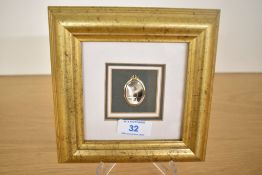 A contemporary micro painting of a mountainous range upon a miniature mother of pearl locket-