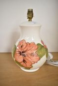 A 20th-century Moorcroft 'hibiscus' pattern ceramic lamp base, featuring tube lined floral