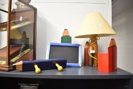 A selection of novelty pencil related items including a table lamp, a money box, a pencil case, coat