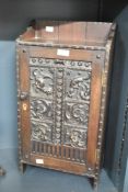 A late 19th-century carved mahogany Gothic Revival-style standing/wall hanging cabinet, featuring