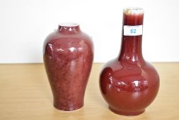 Two Chinese sang-de-boeuf (oxblood) porcelain vases, presumed Qing Dynasty, both featuring deep rich
