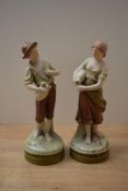 A pair of Royal Dux porcelain water carrier figures comprising model numbers 2221 and 2223, both