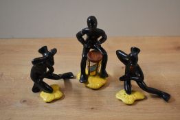 A group of three unusual Goebel porcelain figures depicting a drummer and two dancers, all in matt